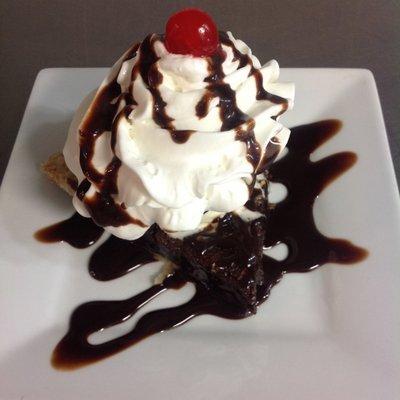 Meet our "boat sinker". Hot brownie pie topped with vanilla ice cream, chocolate syrup, whipped topping, more chocolate syrup, and a cherry.