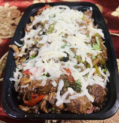 "Experience the Kavsar Special Dish, featuring your choice of beef or chicken, skillet browned and then stewed with sautéed vegetables inclu