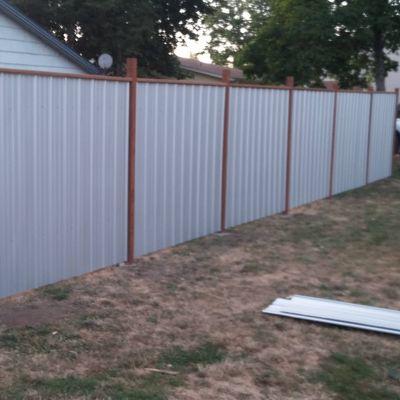 Ribbed galvanized metal and pressure treated post fence for a customer in Jefferson OR