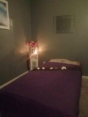 Clean massage room with nice lighting.