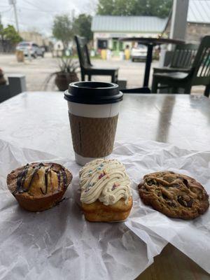 Cup of coffee with three baked goods