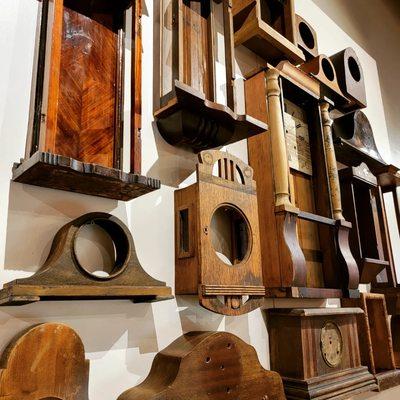 Old wooden clock cases turned into an installation.