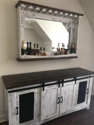 The mirror holds our liquor (multi functional) and the sideboard has plenty of storage!