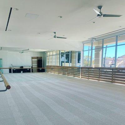 The spacious workout room has floor to ceiling windows with a beautiful view.