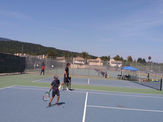 Rallying on orange ball court with Coach Kyle