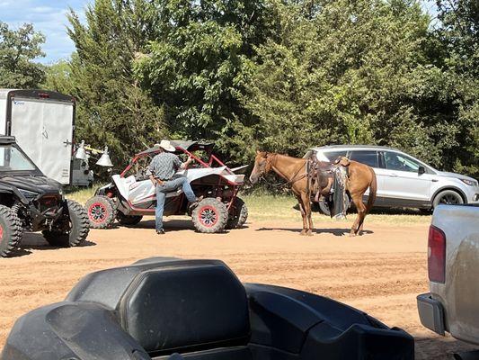 Cowboy talking to a guy in a sxs