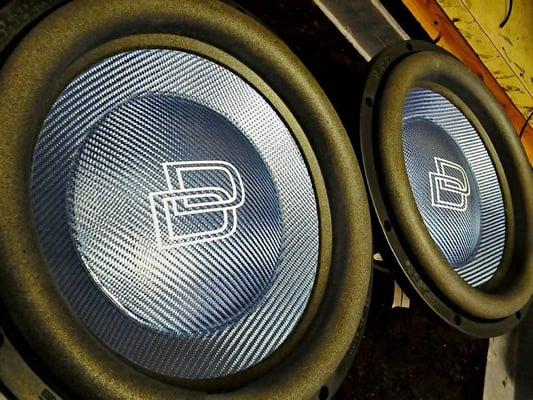 Custom blue carbon fiber subwoofers made by DD Audio.