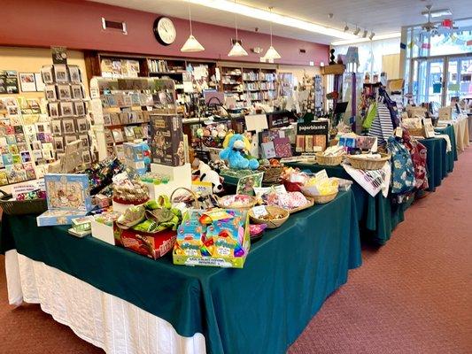 Main table display and checkout counter on left viewing from middle of store to entrance