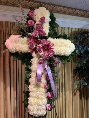 Cross in mums with roses, lilies and eucalyptus