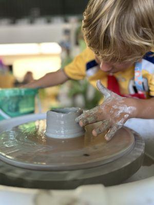 4 year old creating a cup, on day one of camp!