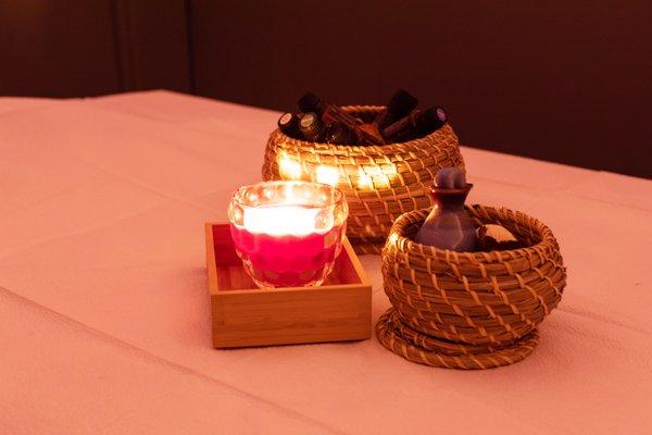 Candle and essential oil at massage bed