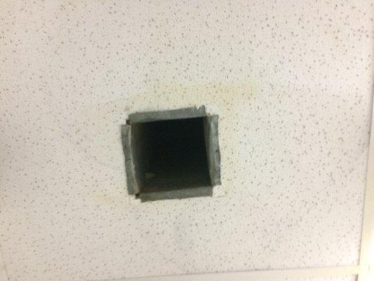 Umm weird hole in ceiling above toilet.