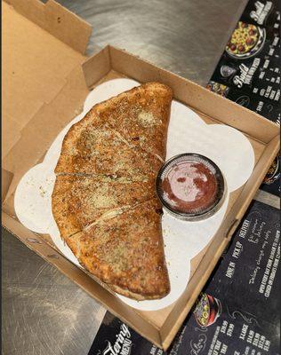 Signature calzone is a delicious, bold creation! It features a perfect blend of gooey mozzarella that melts into every bite.