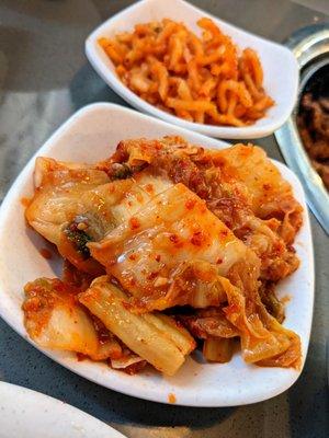 Kimchi and spicy sliced daikon radish banchan (Korean side dishes).