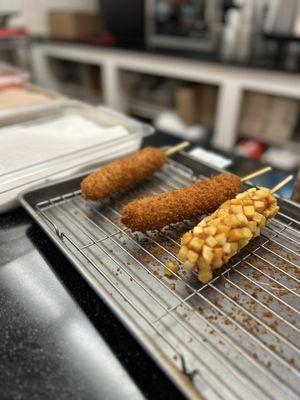 Corn dogs with options of hot Cheetos, cinnamon sugar, and regular sugar