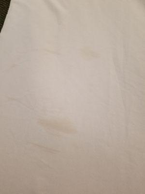 Bedding is stained and has cigarette holes.