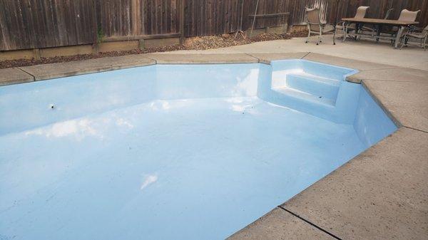 The discoloration at its worst just before the pool was finally refinished in white