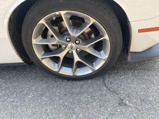 The rubber strip of the bald tire that's stripping from the inside of the tire