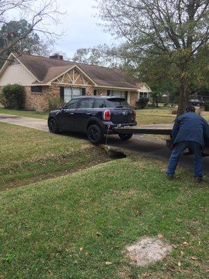 Driver damaged my car. Trying to push it up an incline with the flatbed directly on the car!