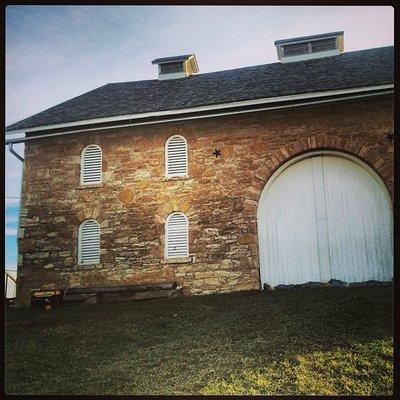 The white doors on the north side create a nice backdrop for ceremonies. with a slight incline which is a natural stage.