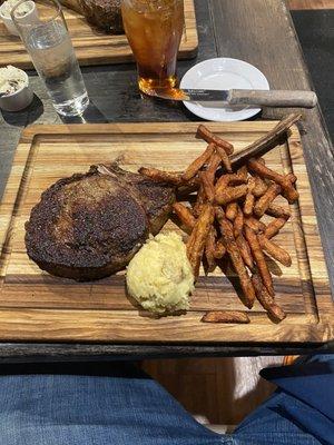 Dry aged Tomahawk ribeye with Sweet potato fries and mashed potatoes