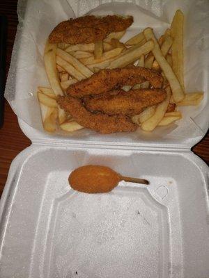 Chicken and fries and I don't know what that is on the stick I think it's like a seafood hush puppie