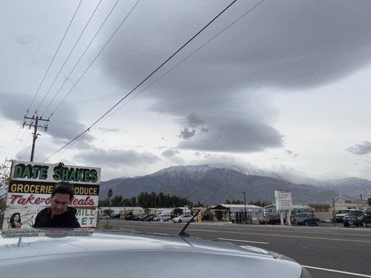 Snow covered mountains beckon from the parking lot.