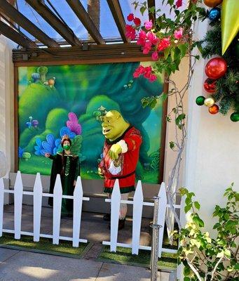 Fiona and Shrek greeting and taking pictures with guests during the 2021 Merry Grinchmas.