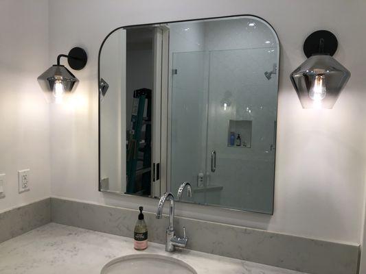 The result is a refreshed bathroom with modern sconces!