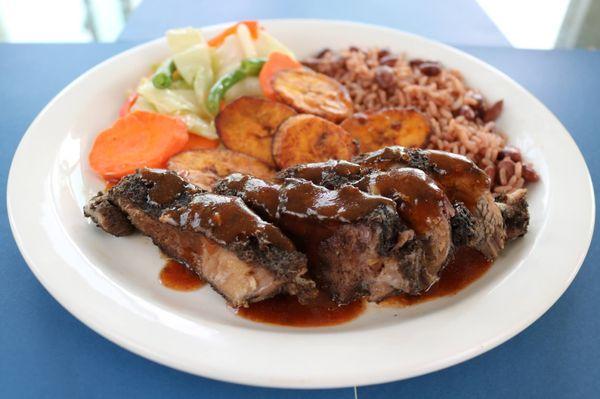 Jerk Pork with Rice and Peas, Steamed Vegetables and Fried Planatins.