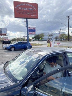 My son paying for his first big auto repair and luckily we found Longhorn - Pepé and his team were great!