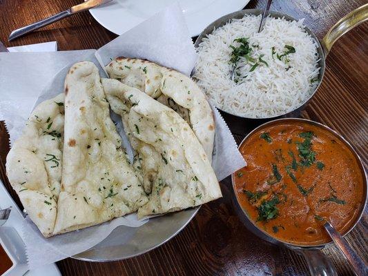 Murgh Tikka Butter Masala (Spice Level 5) with Basmati Rice and Garlic Naan: Chicken tikka cooked in creamy onion tomato sauce with butter