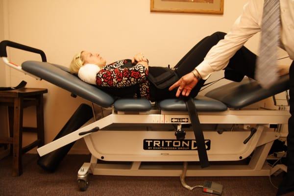 Patient receiving lumbar spinal decompression traction