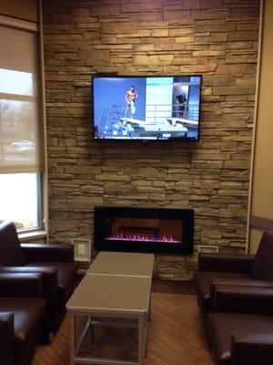 Cozy seating in front of a fireplace and flat screen tv