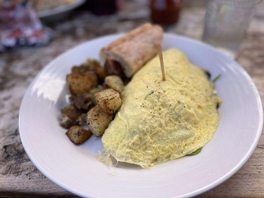 Forestiere omelette with breakfast potatoes-kinda funny it comes with a piece of baguette