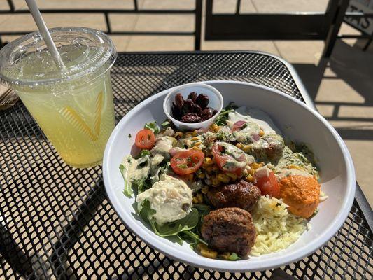 Lamb meatballs, arugula, Bismati rice, feta, tomatoes/red onion, tzatziki sauce .. that's all I remember. Cucumber lime drink!