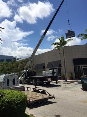 Crane lift with Link Lift to set 6 ton Carrier package unit on roof.