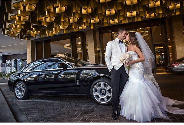 Bride and Groom posing next to Rolls Royce. 1 Hour Getaway Package available now.