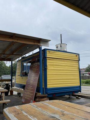 View of the trailer from underneath the other covered seating area.