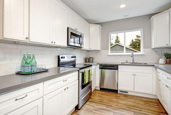 White Shaker Cabinets with Granite Counter-Top, and SPC Flooring