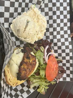 Island burger with potato salad.