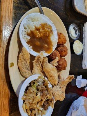 Fried catfish filet lunch special with cabbage, rice and gravy.