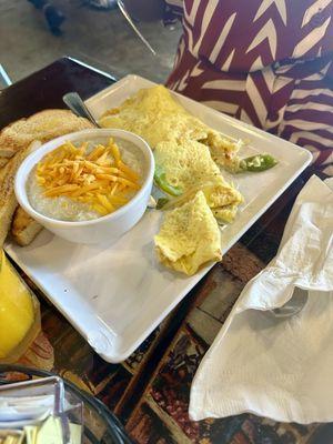 Shrimp fajita omelette with toast, cheese grits and orange juice.