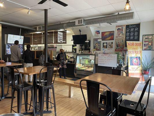 Casual dining tables in front, order at the counter.