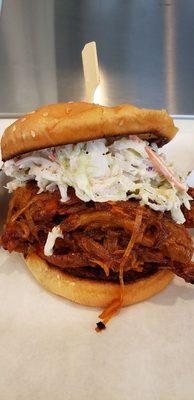 Smoked Tri-Tip Sandwich with caramelized onions, tossed in BBQ sauce and topped with house made Southern style Cole slaw