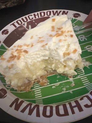 1/2 eaten piece of coconut cream pie.