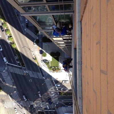 VIP Special Services Window Cleaners rappelling via boatswains chairs high above the streets on a beautiful Spring day.