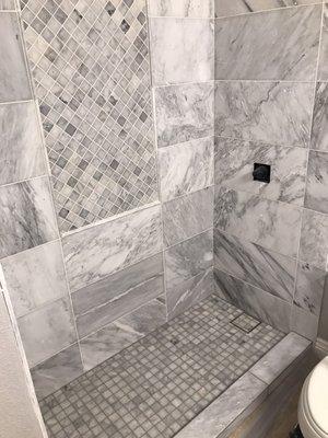 Custom shower, wall insert and niche all in Marble.