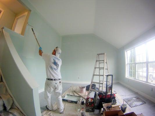 Nick Dunse rolling out walls in a condo recently purchased by a new customer.