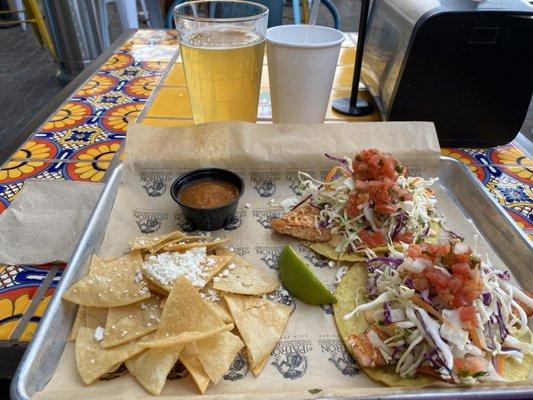 Blackened salmon taco special with chips, salsa and a beer